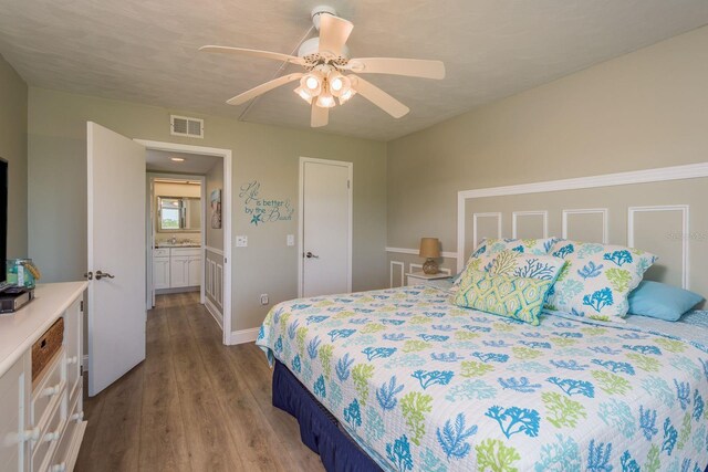 19451 Gulf Blvd Unit 204, Indian Shores, FL 33785 - bedroom with wood finished floors, visible vents, a ceiling fan, a sink, and baseboards
