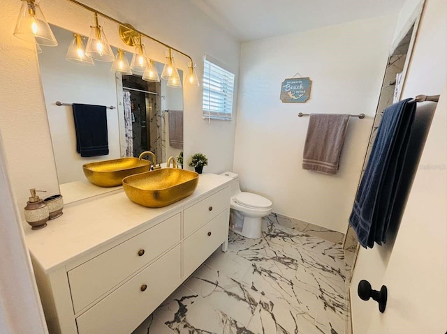 bathroom with a shower with door, vanity, and toilet