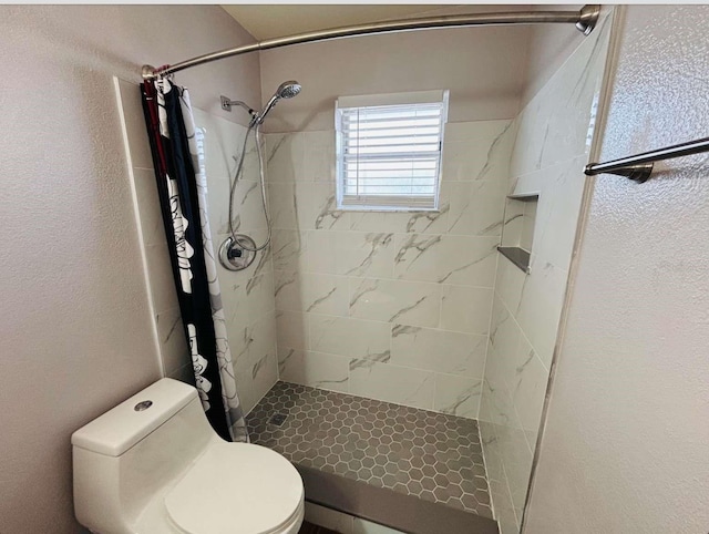 bathroom with a shower with curtain and toilet