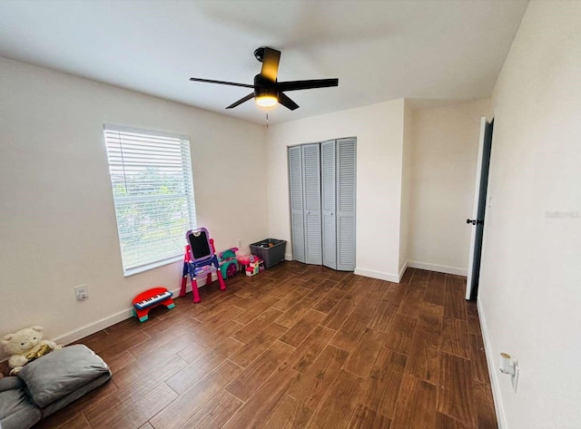 rec room with dark hardwood / wood-style flooring and ceiling fan