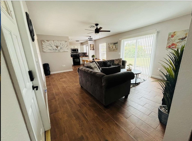 living room featuring hardwood / wood-style floors and ceiling fan