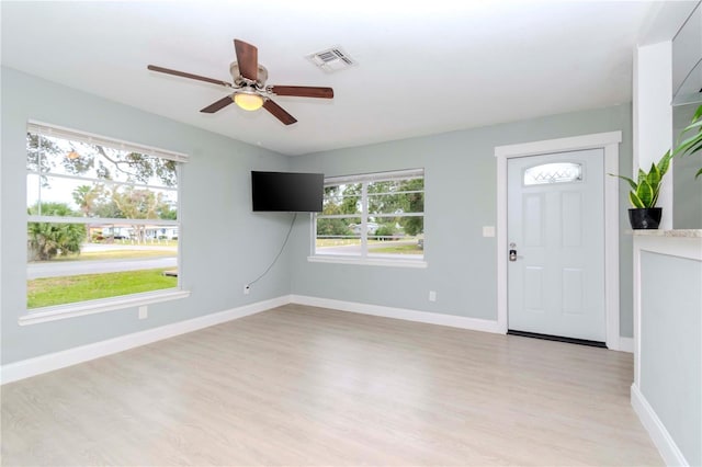 foyer entrance with ceiling fan and light hardwood / wood-style floors