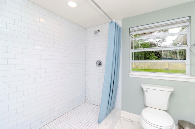 bathroom with toilet and a shower with shower curtain