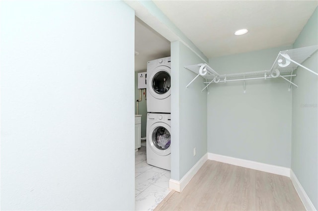 washroom featuring stacked washer / dryer