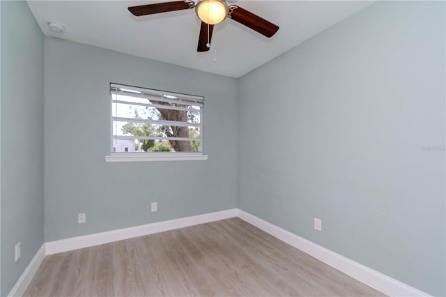 spare room with ceiling fan and light wood-type flooring