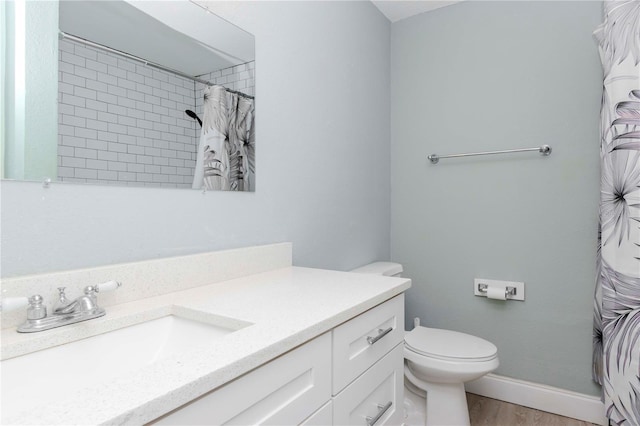 bathroom featuring wood-type flooring, a shower with curtain, vanity, and toilet