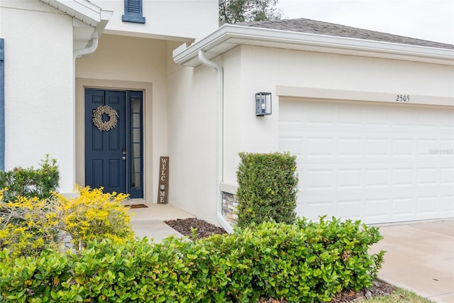 view of exterior entry featuring a garage