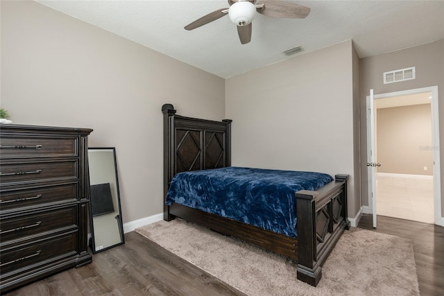 bedroom with ceiling fan and dark wood-type flooring