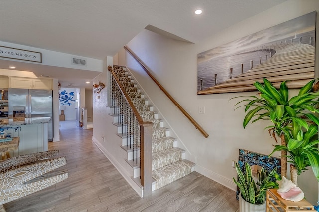 stairway featuring hardwood / wood-style flooring