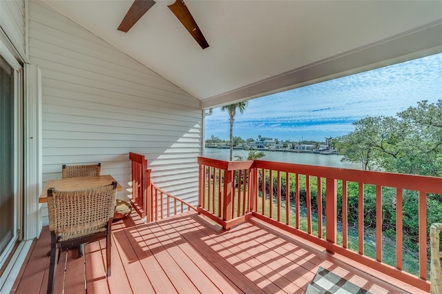 wooden deck with ceiling fan and a water view