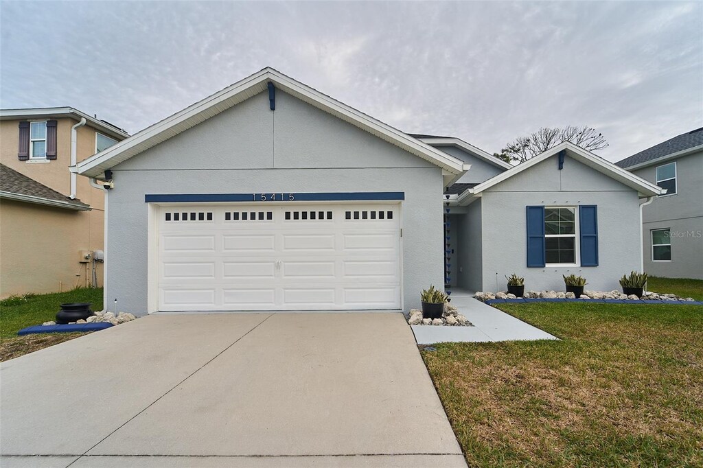 view of front of property with a front yard and a garage