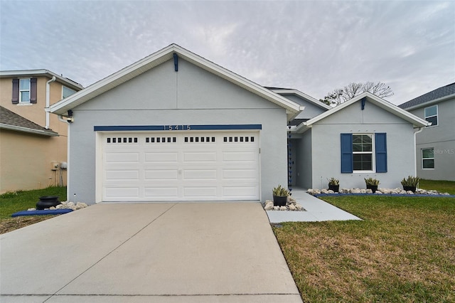 view of front of property with a front yard and a garage