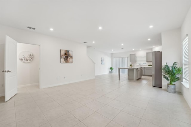 unfurnished living room featuring light tile patterned floors