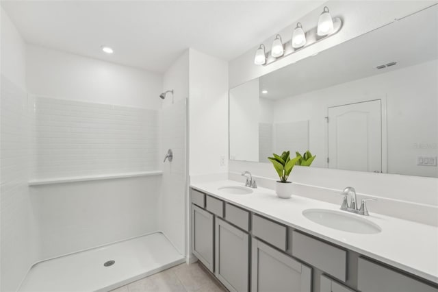 bathroom featuring a shower, tile patterned floors, and vanity