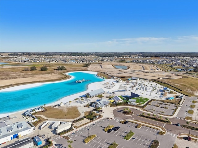 birds eye view of property featuring a beach view and a water view