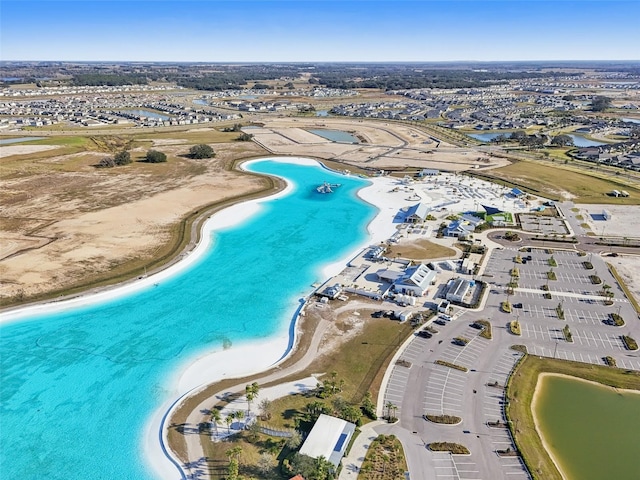 birds eye view of property featuring a beach view and a water view