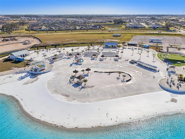 bird's eye view with a water view and a view of the beach