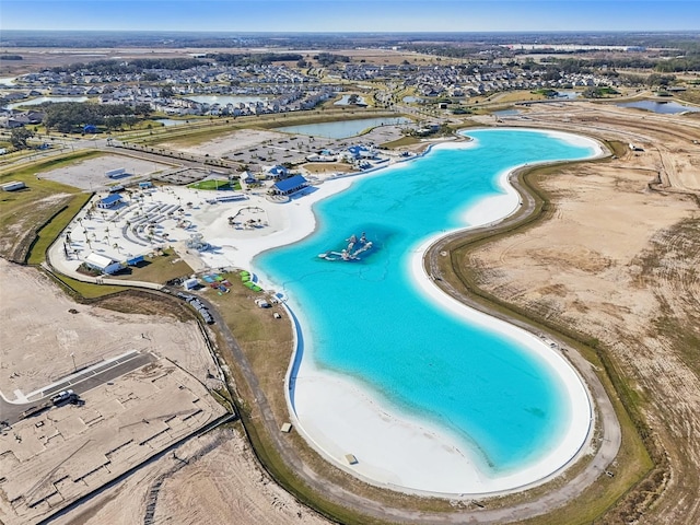 aerial view with a water view and a view of the beach