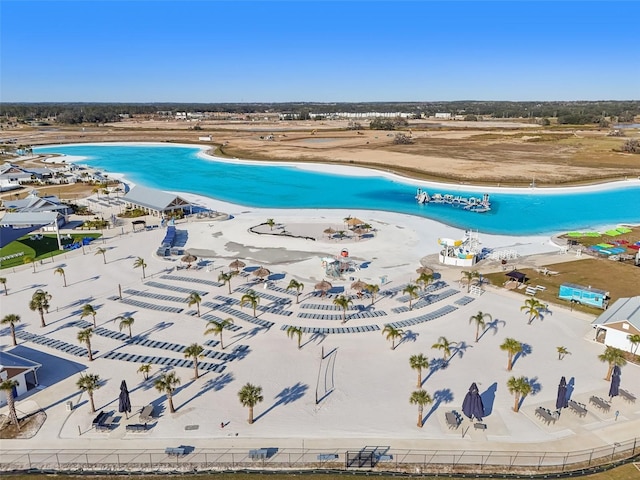 drone / aerial view featuring a water view and a view of the beach