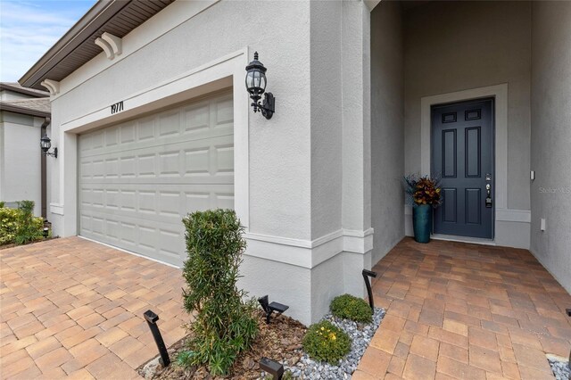 garage featuring decorative driveway