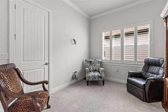 sitting room with carpet floors, ornamental molding, and baseboards