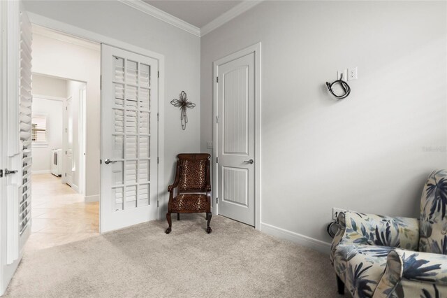 living area featuring baseboards, ornamental molding, and light colored carpet