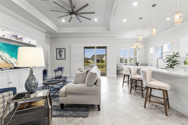 living room with a tray ceiling, crown molding, baseboards, and recessed lighting