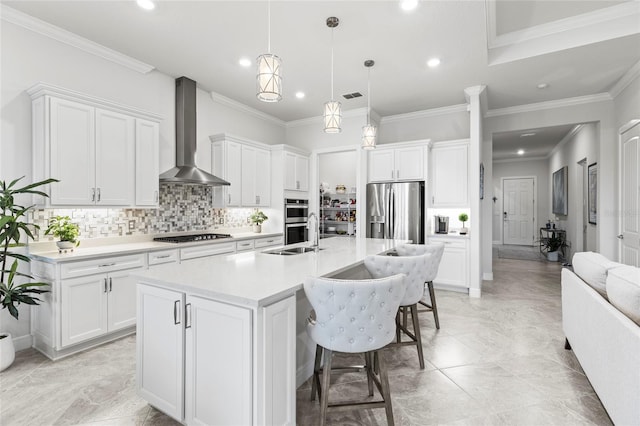 kitchen featuring tasteful backsplash, visible vents, wall chimney exhaust hood, appliances with stainless steel finishes, and light countertops