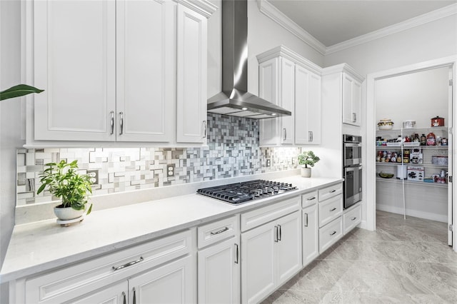 kitchen with crown molding, tasteful backsplash, appliances with stainless steel finishes, white cabinets, and wall chimney range hood