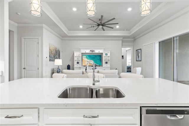 kitchen with light stone counters, a sink, open floor plan, dishwasher, and a tray ceiling