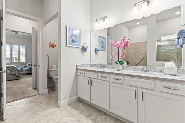 ensuite bathroom featuring double vanity, a sink, toilet, and a walk in shower