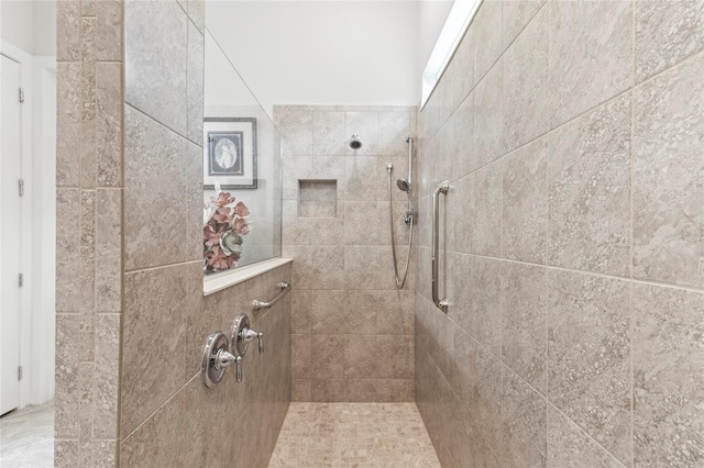 full bathroom with a tile shower