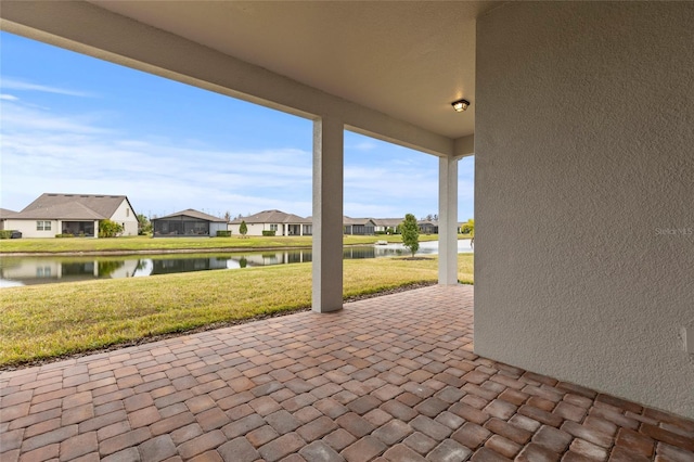 view of patio / terrace featuring a water view and a residential view