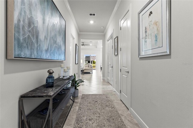 corridor featuring baseboards, visible vents, and crown molding