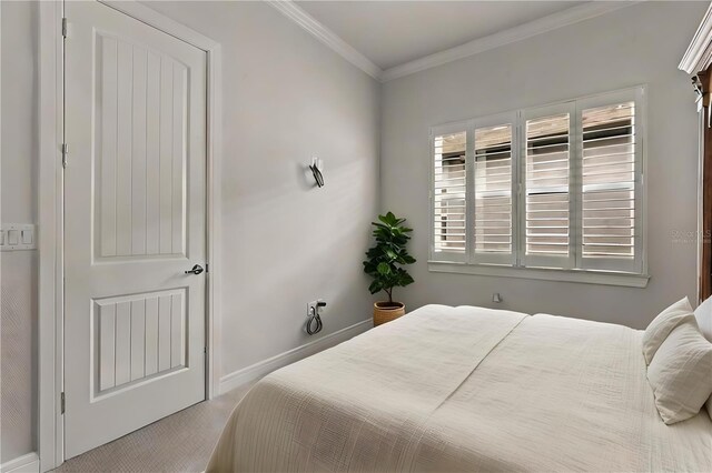 bedroom featuring baseboards, carpet flooring, and crown molding