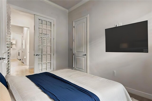 bedroom with crown molding and baseboards