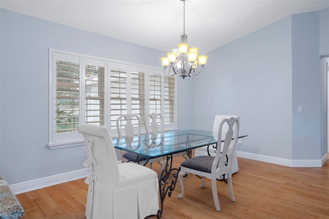 dining room featuring an inviting chandelier and light hardwood / wood-style flooring