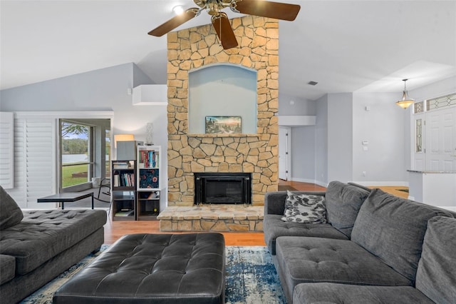 living room featuring ceiling fan, lofted ceiling, a fireplace, and hardwood / wood-style flooring