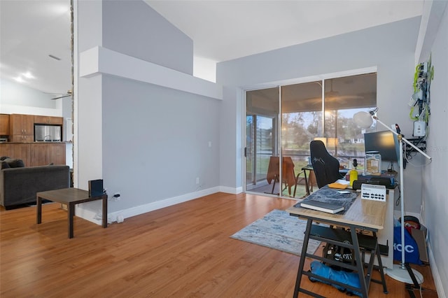 office with ceiling fan, vaulted ceiling, and wood-type flooring