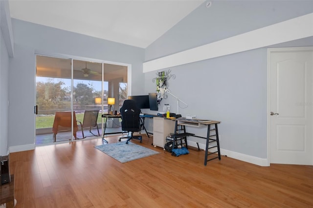 home office featuring ceiling fan, hardwood / wood-style floors, and vaulted ceiling