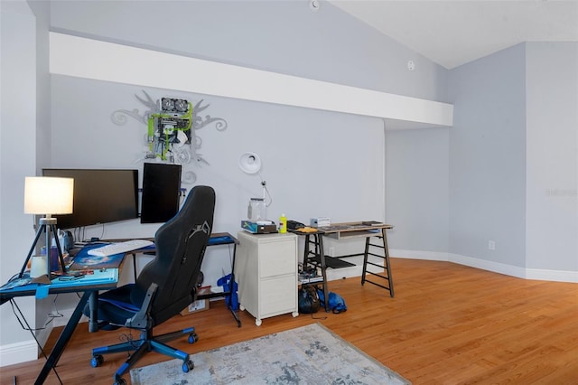 office area with vaulted ceiling and wood-type flooring