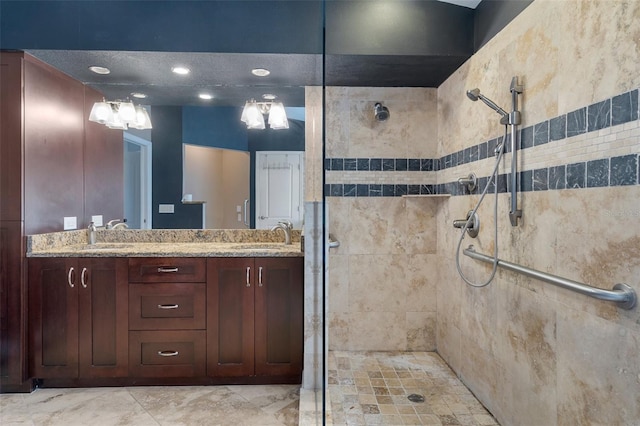 bathroom featuring a tile shower and vanity