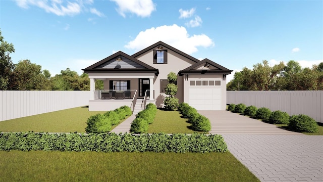 view of front of home with covered porch, a front yard, and a garage