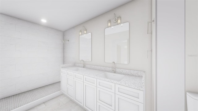 bathroom with vanity, tile patterned floors, and tiled shower