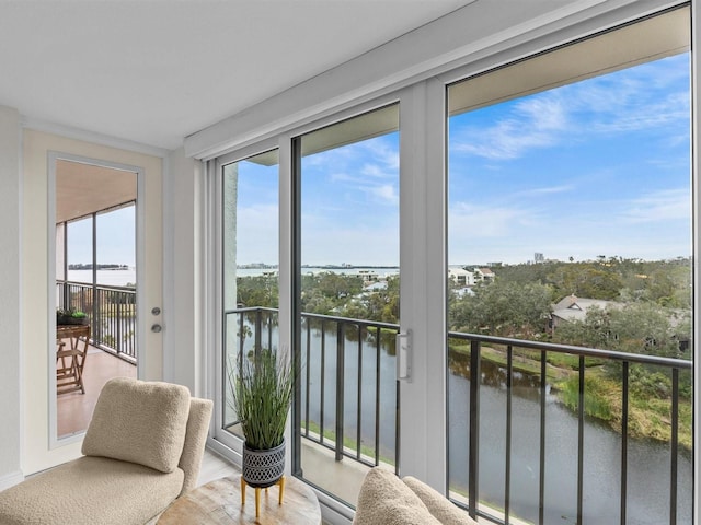 sunroom / solarium featuring a water view