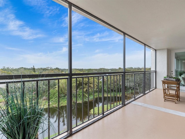 unfurnished sunroom featuring a water view and a wealth of natural light