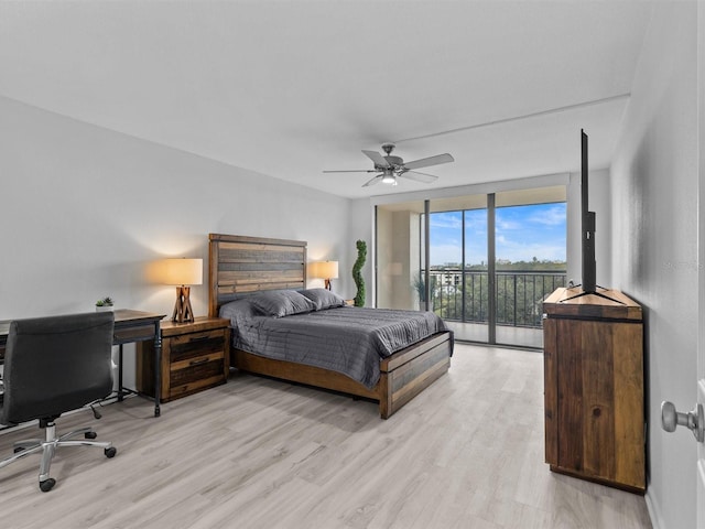 bedroom featuring ceiling fan, access to exterior, light hardwood / wood-style floors, and floor to ceiling windows