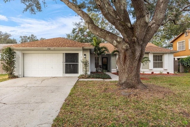 ranch-style home with a garage and a front yard