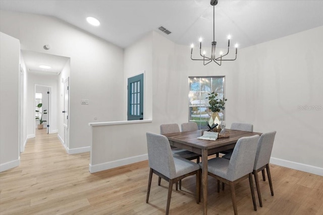 dining room featuring light hardwood / wood-style floors and a notable chandelier