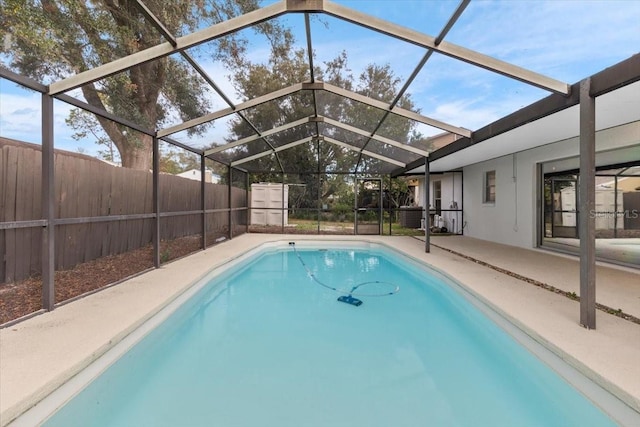 view of pool with a lanai and a patio area